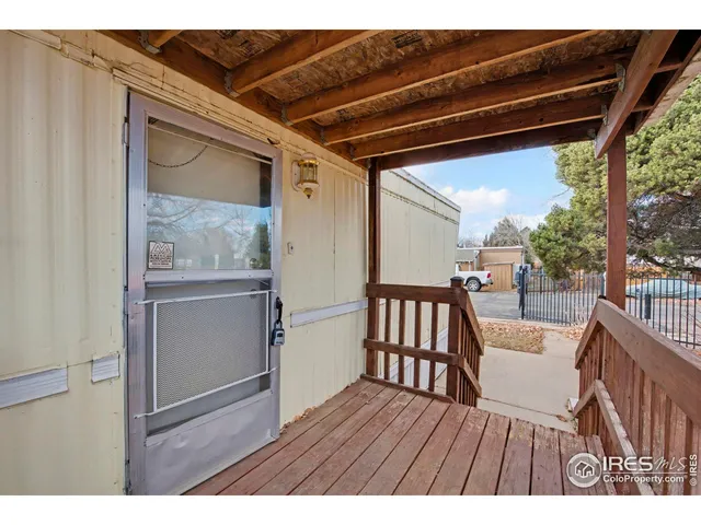 a view of a porch with wooden floor and outdoor seating