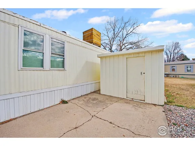 a view of a house with backyard and wooden fence