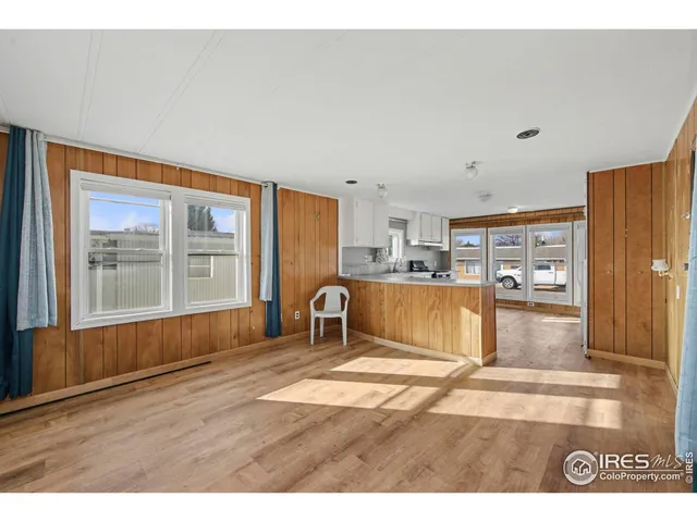 a living room with kitchen island granite countertop furniture and a large window