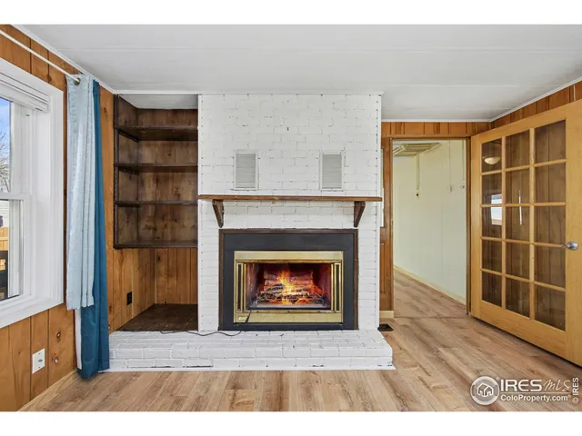 a living room with a fireplace and a wooden floor