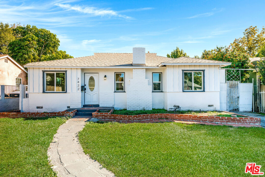 7422 Milwood Avenue Canoga Park, CA 91303 - Photo 1 of 15 a front view of a house with a yard