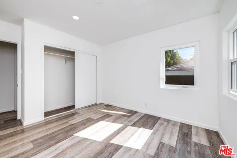a view of an empty room and wooden floor