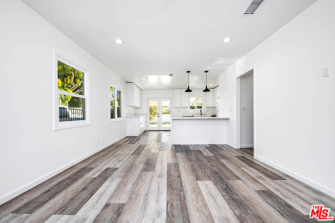 7422 Milwood Avenue Canoga Park, CA 91303 - Photo 3 of 15 a view of a kitchen with wooden floor and windows