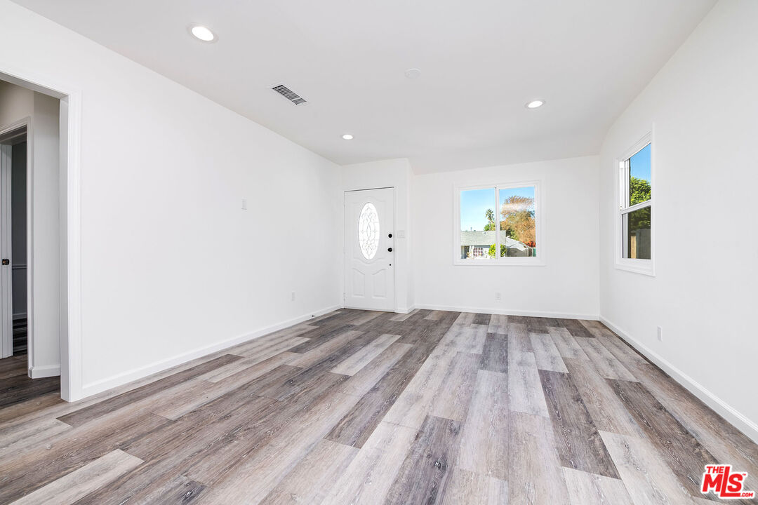 7422 Milwood Avenue Canoga Park, CA 91303 - Photo 4 of 15 wooden floor in an empty room with a window