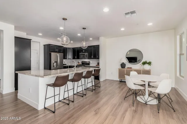 a view of a dining room with furniture and wooden floor