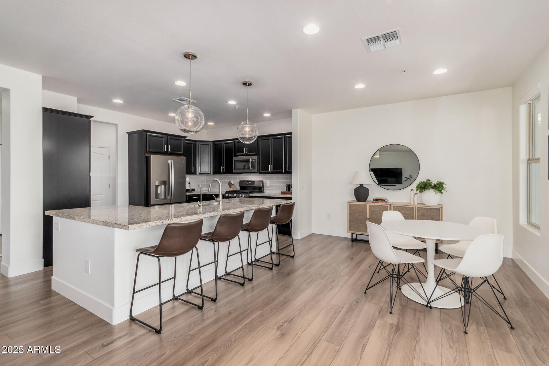 2425 West Bronco Butte Trail, Unit 2010 Phoenix, AZ 85085 - Photo 13 of 44 a view of a dining room with furniture and wooden floor