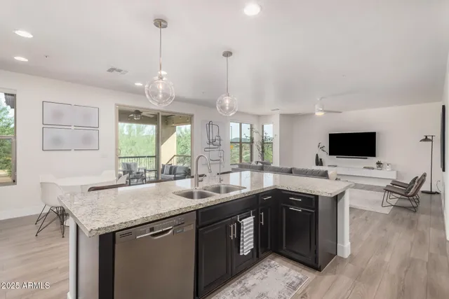 a kitchen with a sink and wooden floor