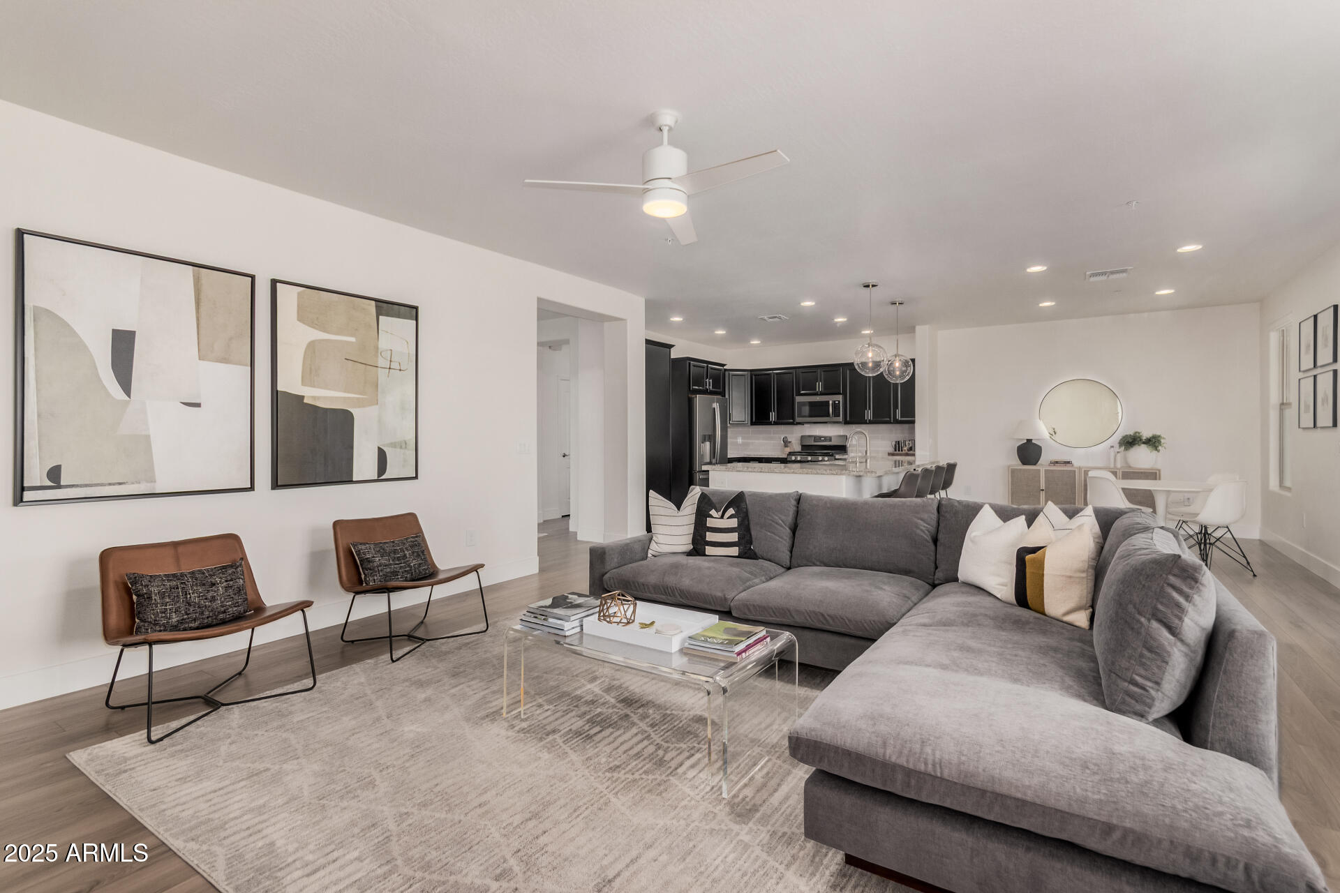 2425 West Bronco Butte Trail, Unit 2010 Phoenix, AZ 85085 - Photo 2 of 44 a living room with furniture and a view of kitchen