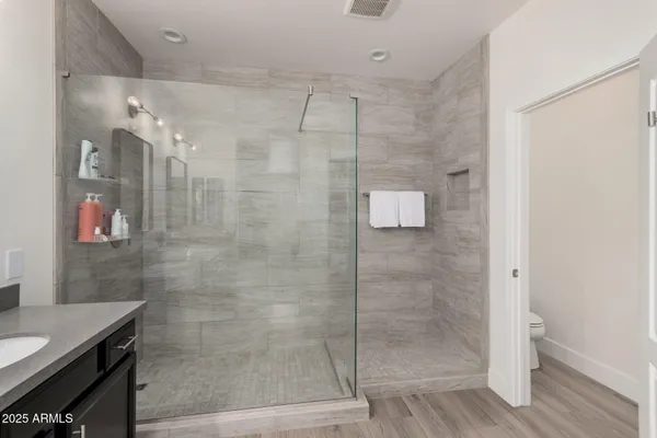 a bathroom with a shower and a sink
