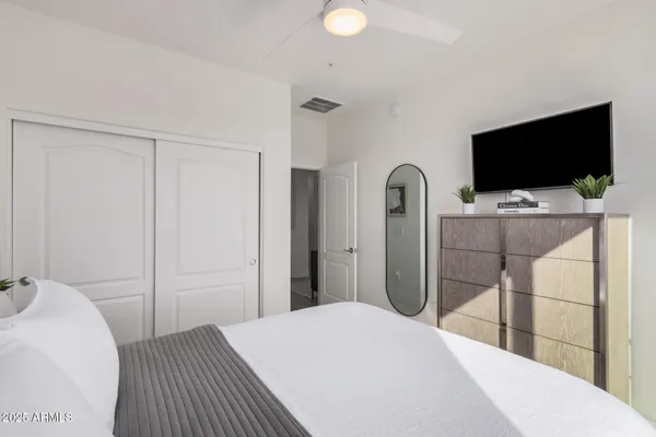 a bedroom with a bed and a flat screen tv