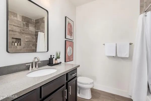 a bathroom with double sink and a mirror