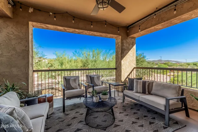 a balcony with furniture and wooden floor