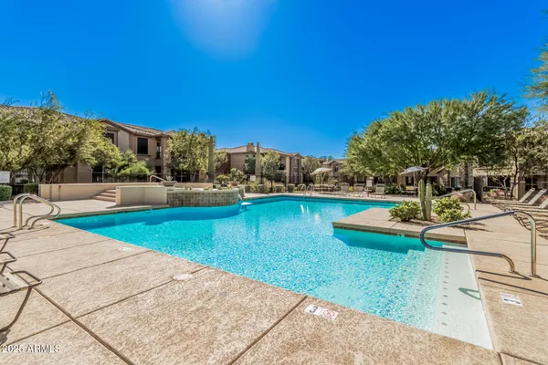 a view of a swimming pool with a lounge chairs