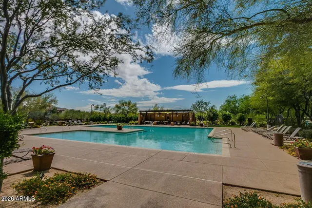 a view of a lake with a patio and a garden