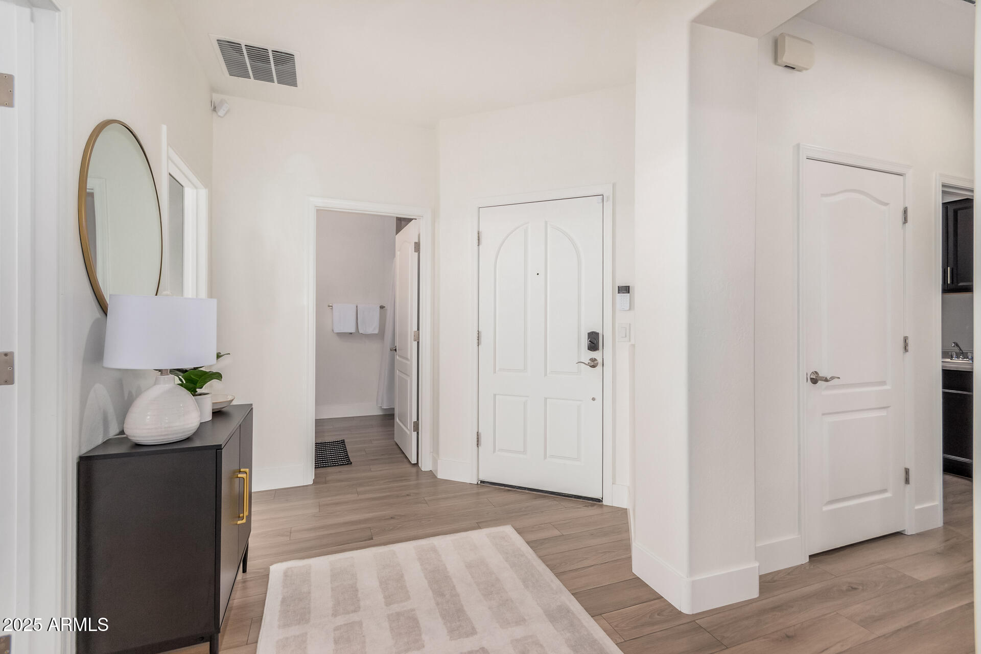 2425 West Bronco Butte Trail, Unit 2010 Phoenix, AZ 85085 - Photo 7 of 44 a view of an entryway with wooden floor