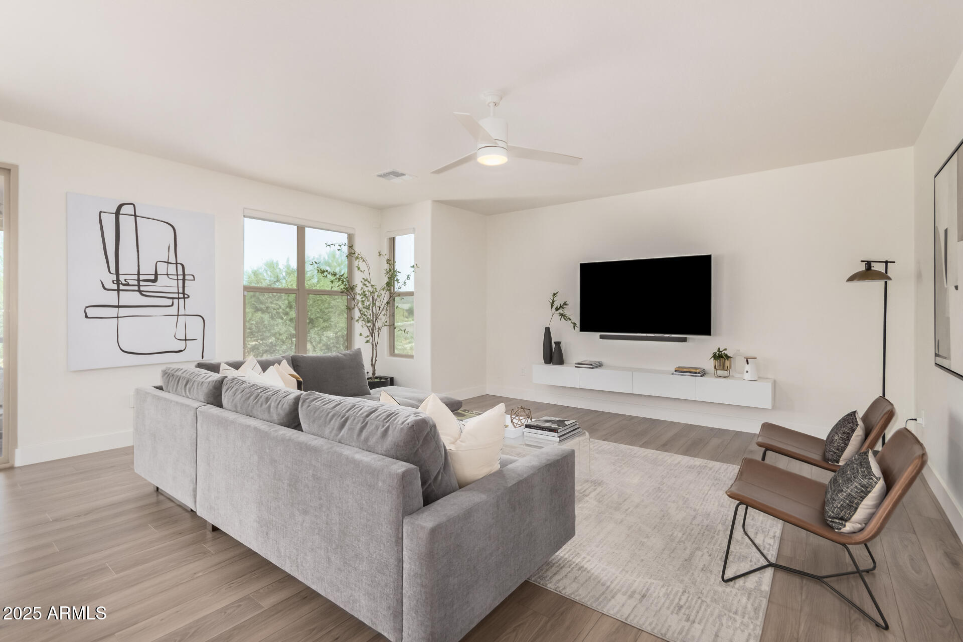 2425 West Bronco Butte Trail, Unit 2010 Phoenix, AZ 85085 - Photo 8 of 44 a living room with furniture and a flat screen tv