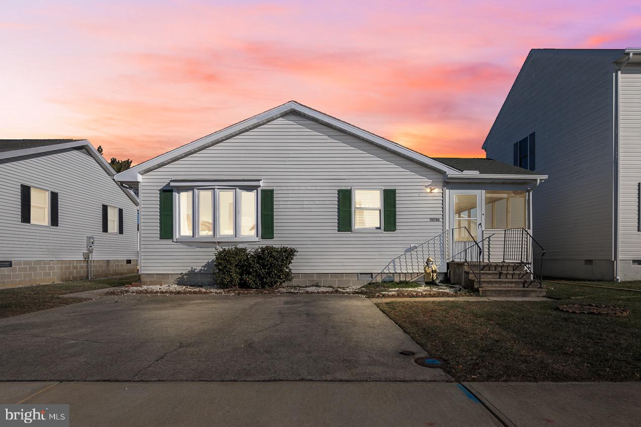 13700 Fiesta Road Ocean City, MD 21842 - Photo 1 of 31 a front view of a house with a yard