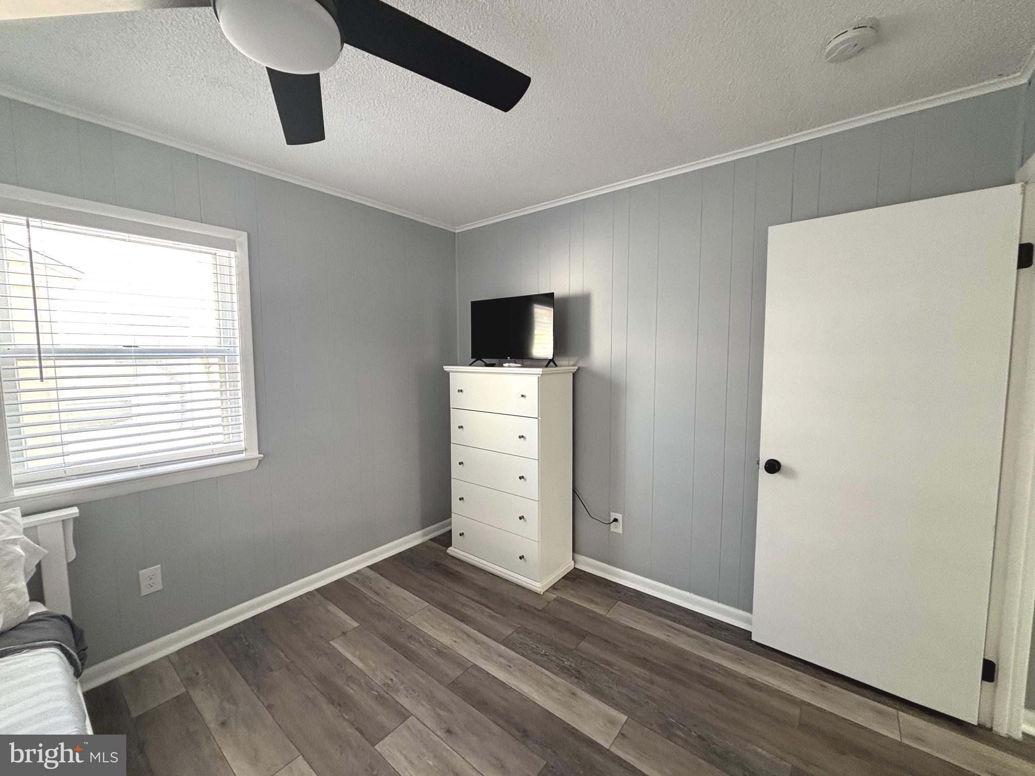 13700 Fiesta Road Ocean City, MD 21842 - Photo 19 of 31 a view of empty room with wooden floor and fan