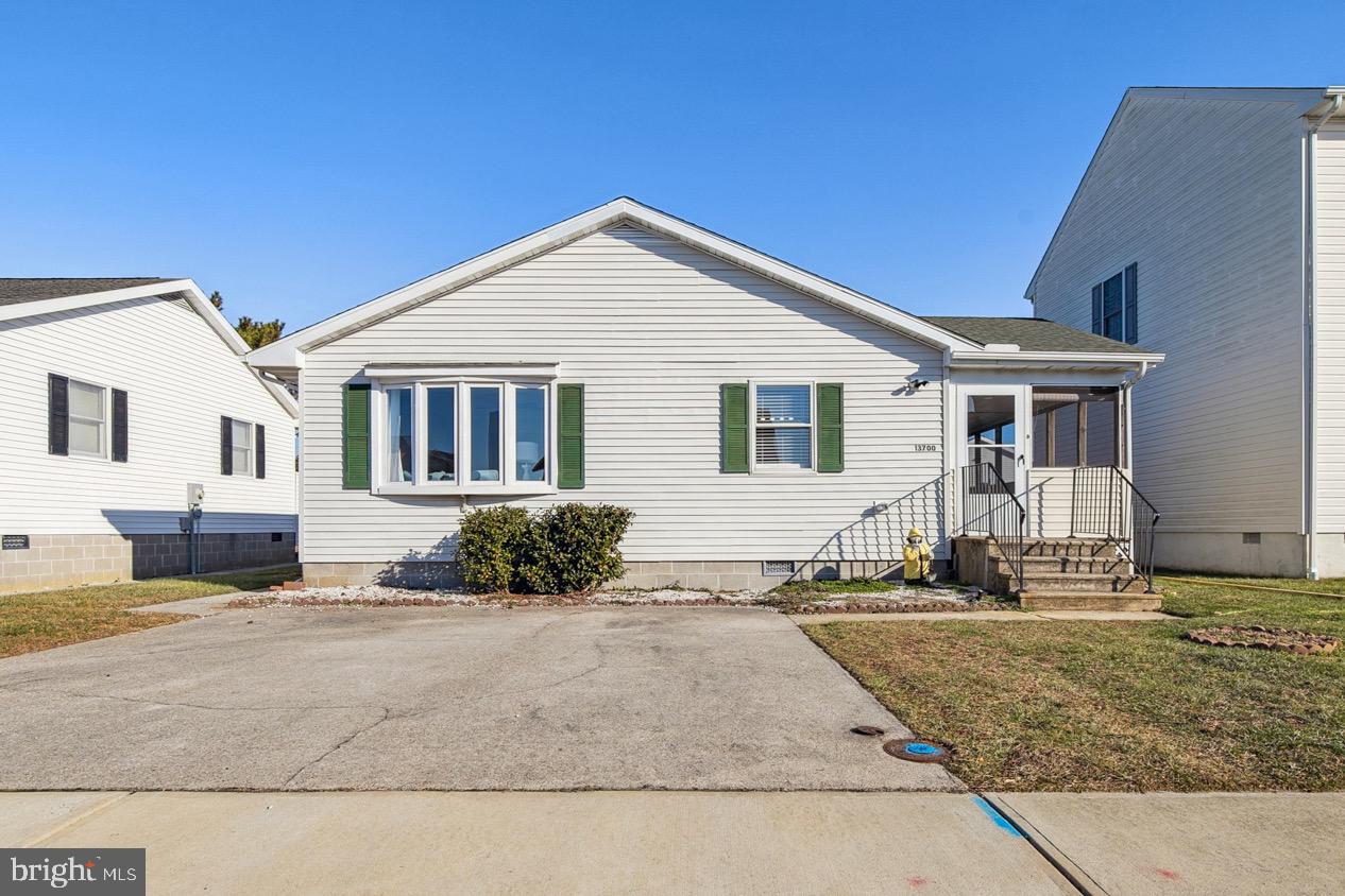 13700 Fiesta Road Ocean City, MD 21842 - Photo 21 of 31 a front view of a house with a yard