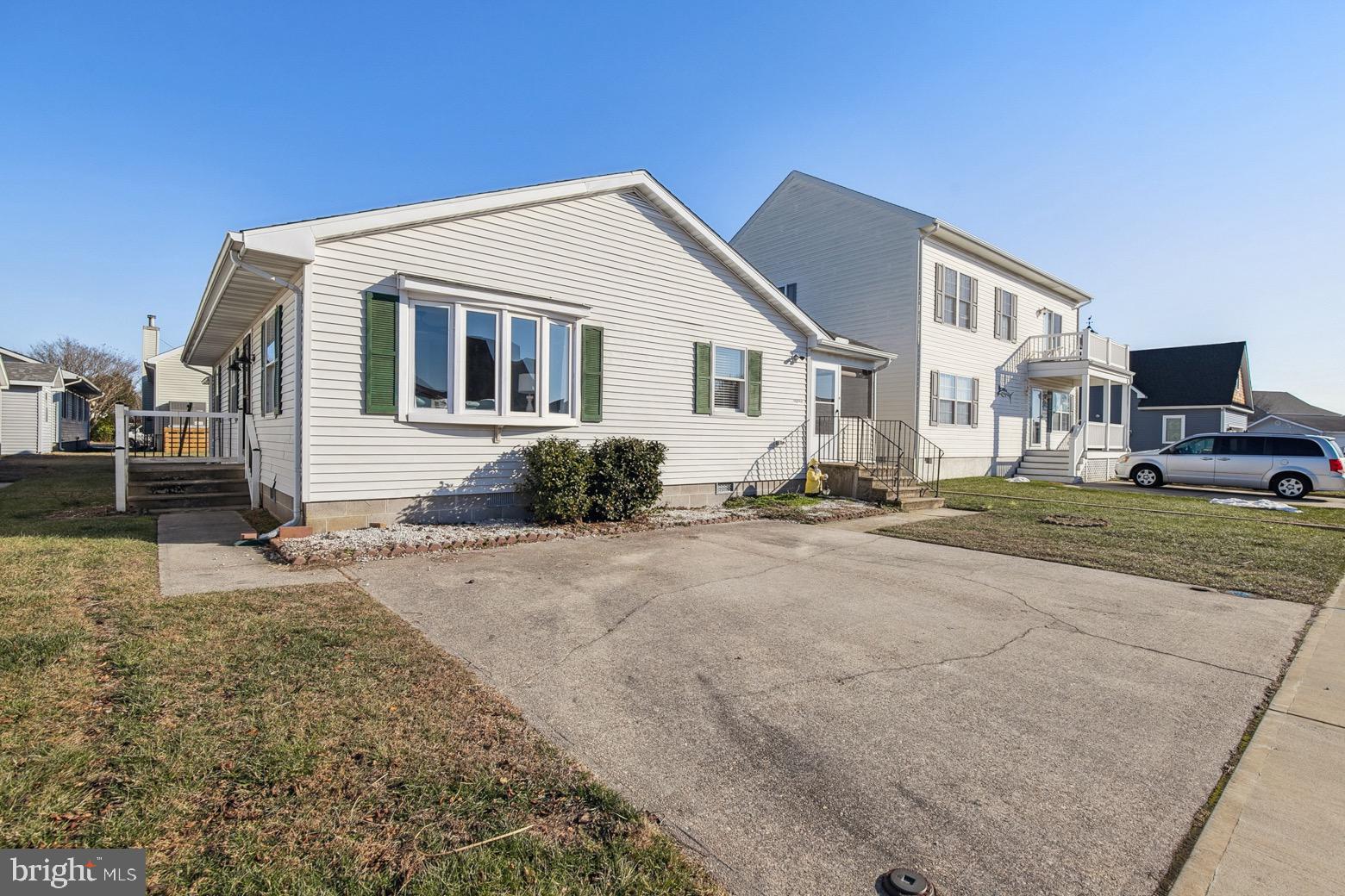 13700 Fiesta Road Ocean City, MD 21842 - Photo 22 of 31 a front view of a house with a yard