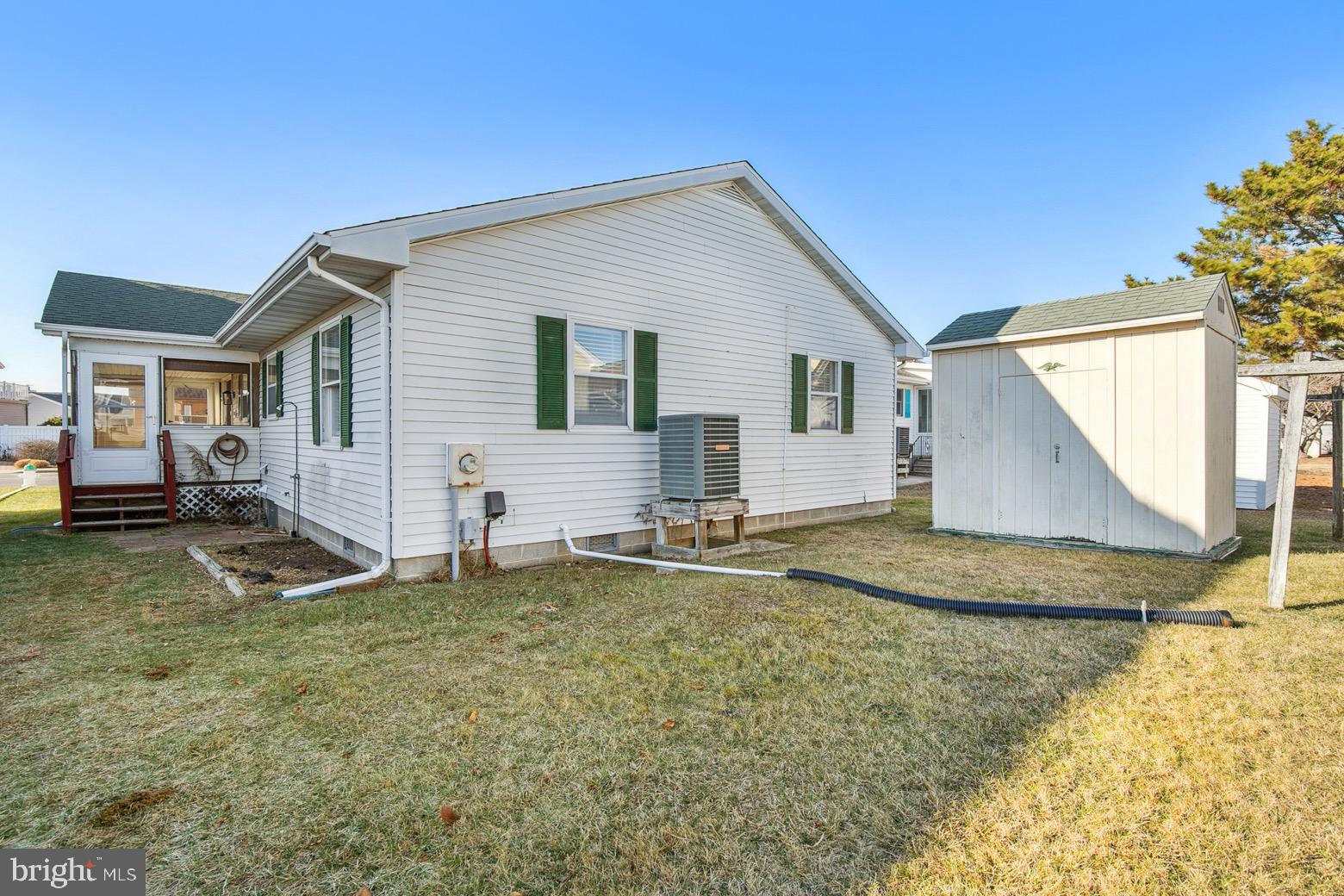 13700 Fiesta Road Ocean City, MD 21842 - Photo 23 of 31 a backyard of a house with barbeque oven table and chairs