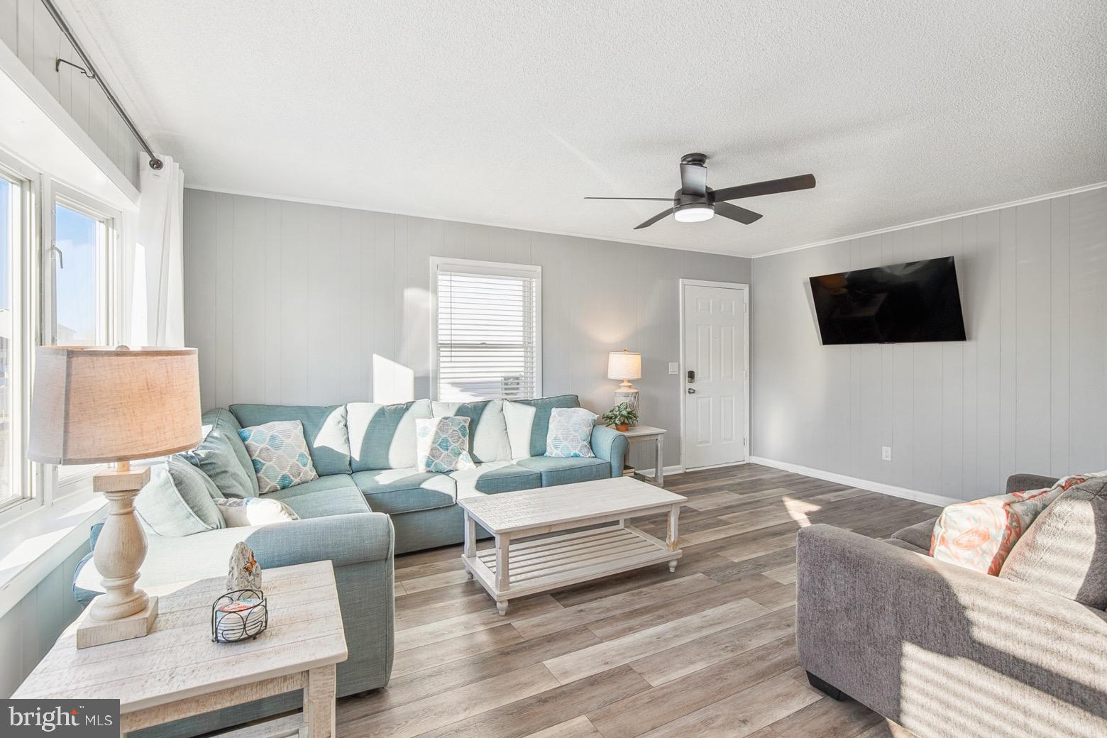 13700 Fiesta Road Ocean City, MD 21842 - Photo 3 of 31 a living room with furniture a flat screen tv and a window