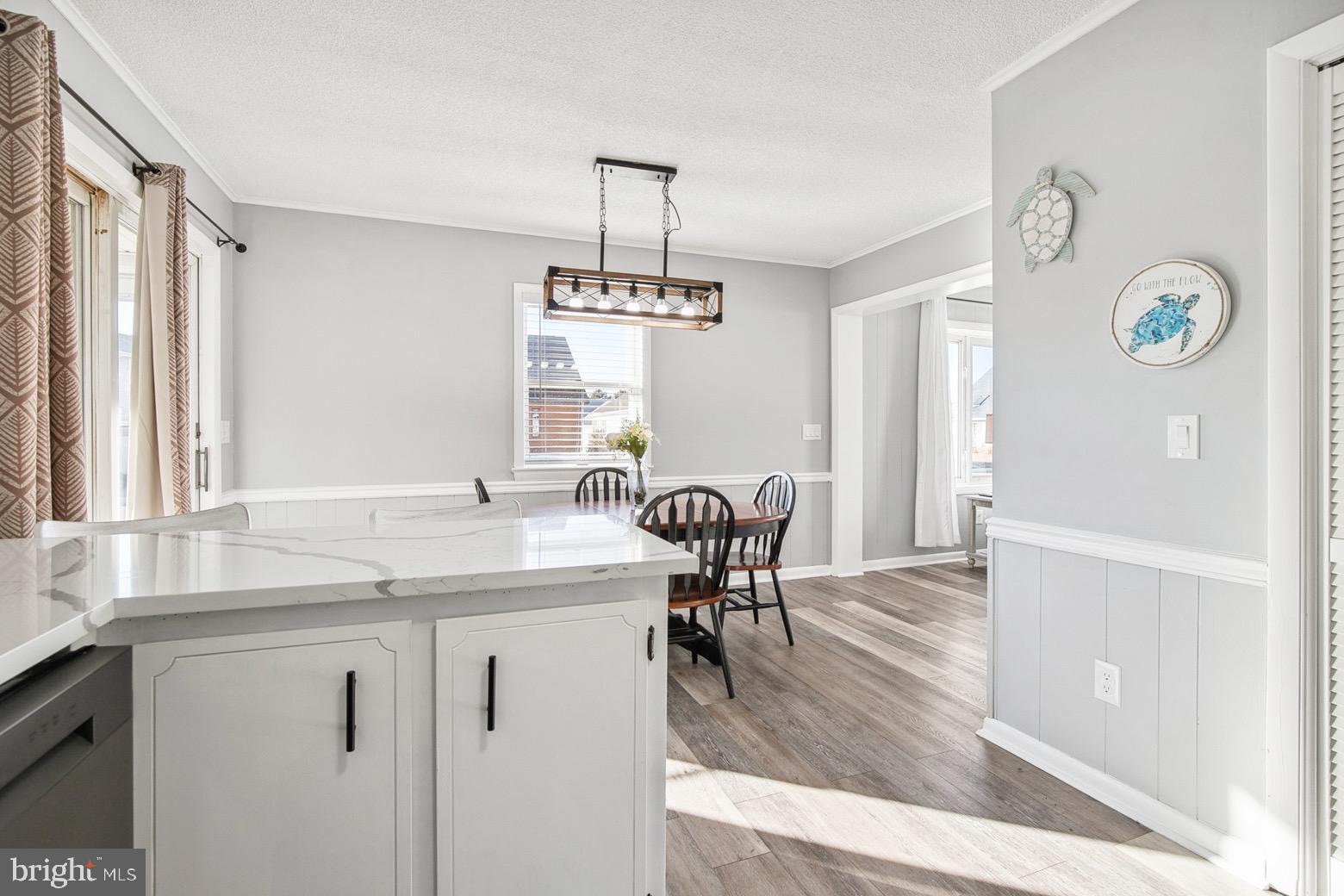 13700 Fiesta Road Ocean City, MD 21842 - Photo 7 of 31 a view of a dining room with furniture window and wooden floor