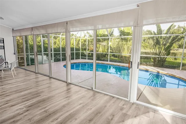 a view of a room with wooden floor and windows
