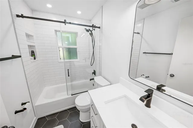 a bathroom with a sink a toilet and a bathtub