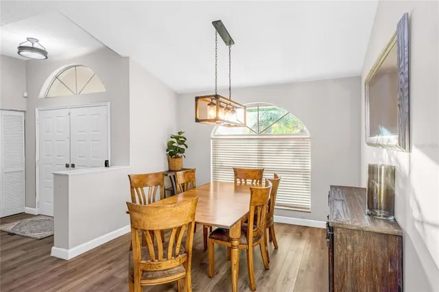 a view of a dining room with furniture window and wooden floor