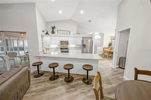 a large kitchen with a table and chairs in it