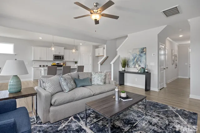 a kitchen with granite countertop white cabinets and stainless steel appliances