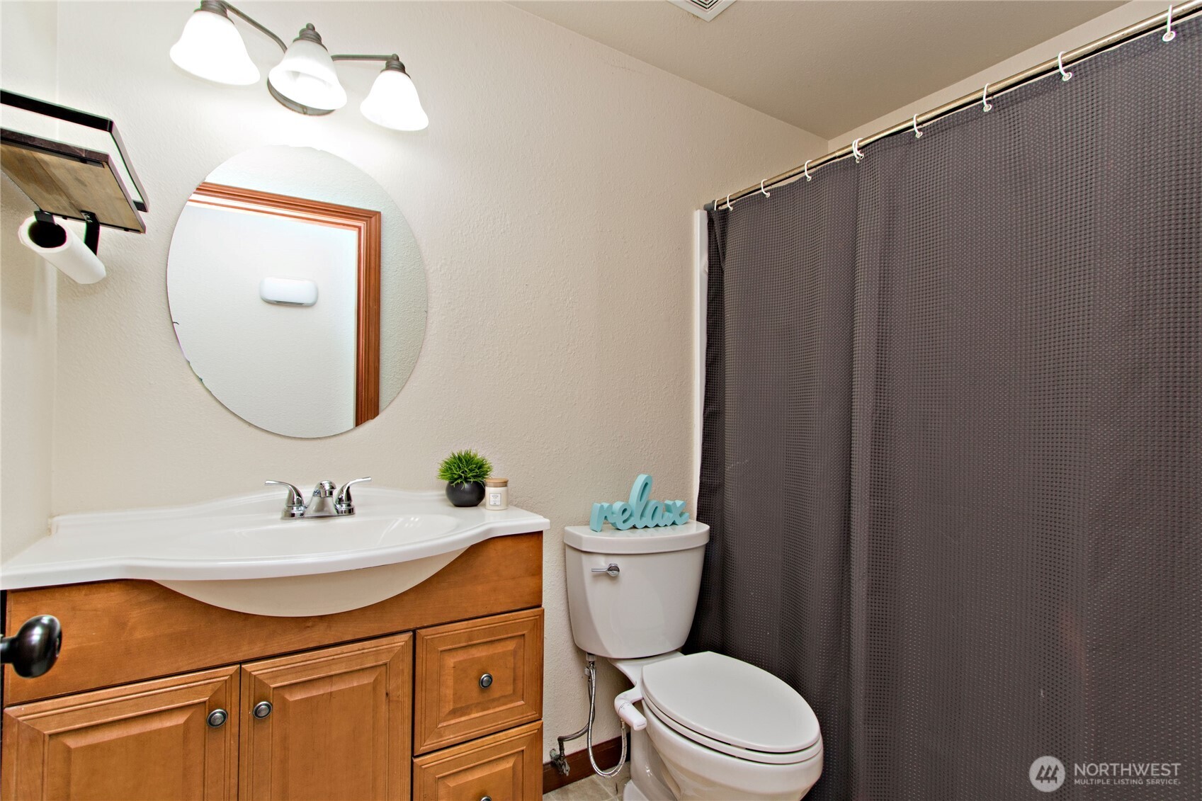 4237 South 326th Place Federal Way, WA 98001 - Photo 9 of 24 a bathroom with a sink a mirror a toilet and vanity