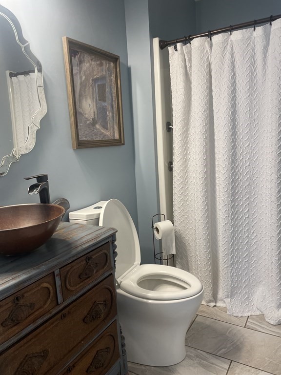 128 Colonial Road Marshfield, MA 02050 - Photo 11 of 21 a bathroom with a toilet a sink and a mirror