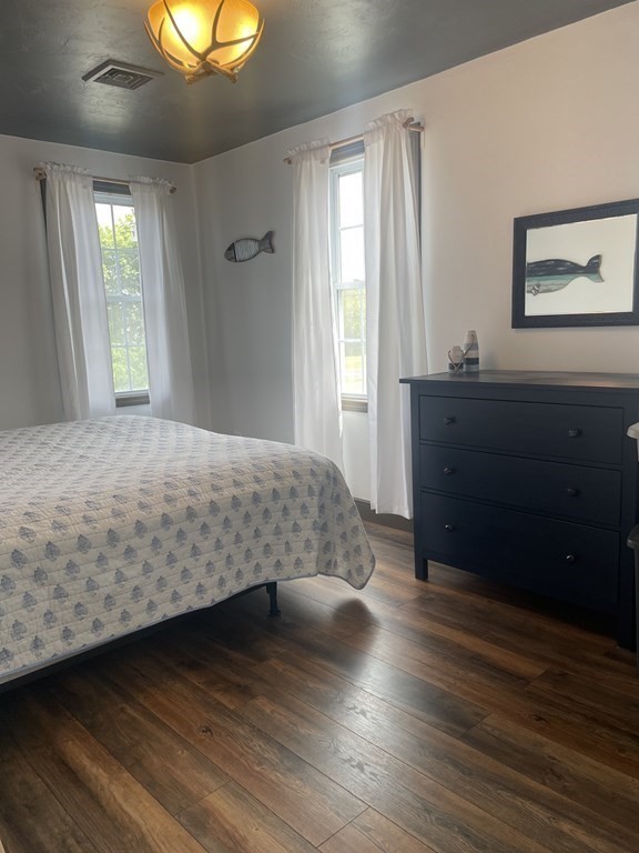 128 Colonial Road Marshfield, MA 02050 - Photo 14 of 21 a bedroom with a bed and a chandelier