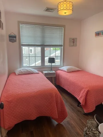 a bedroom with two beds and a window