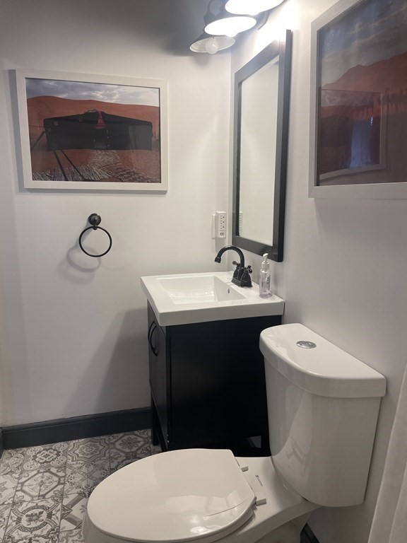 128 Colonial Road Marshfield, MA 02050 - Photo 20 of 21 a white toilet sitting next to a bathroom sink