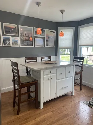a view of a kitchen with cabinets and wooden floor