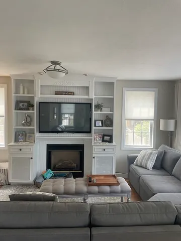 a living room with furniture and a fireplace