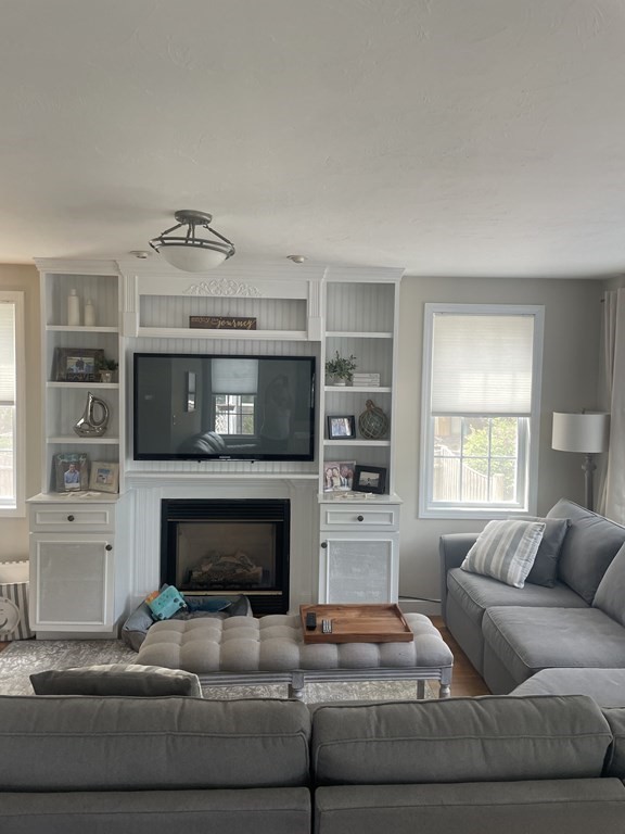 128 Colonial Road Marshfield, MA 02050 - Photo 6 of 21 a living room with furniture and a fireplace