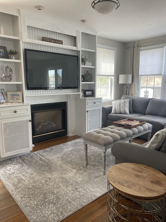 128 Colonial Road Marshfield, MA 02050 - Photo 8 of 21 a living room with furniture and a fireplace