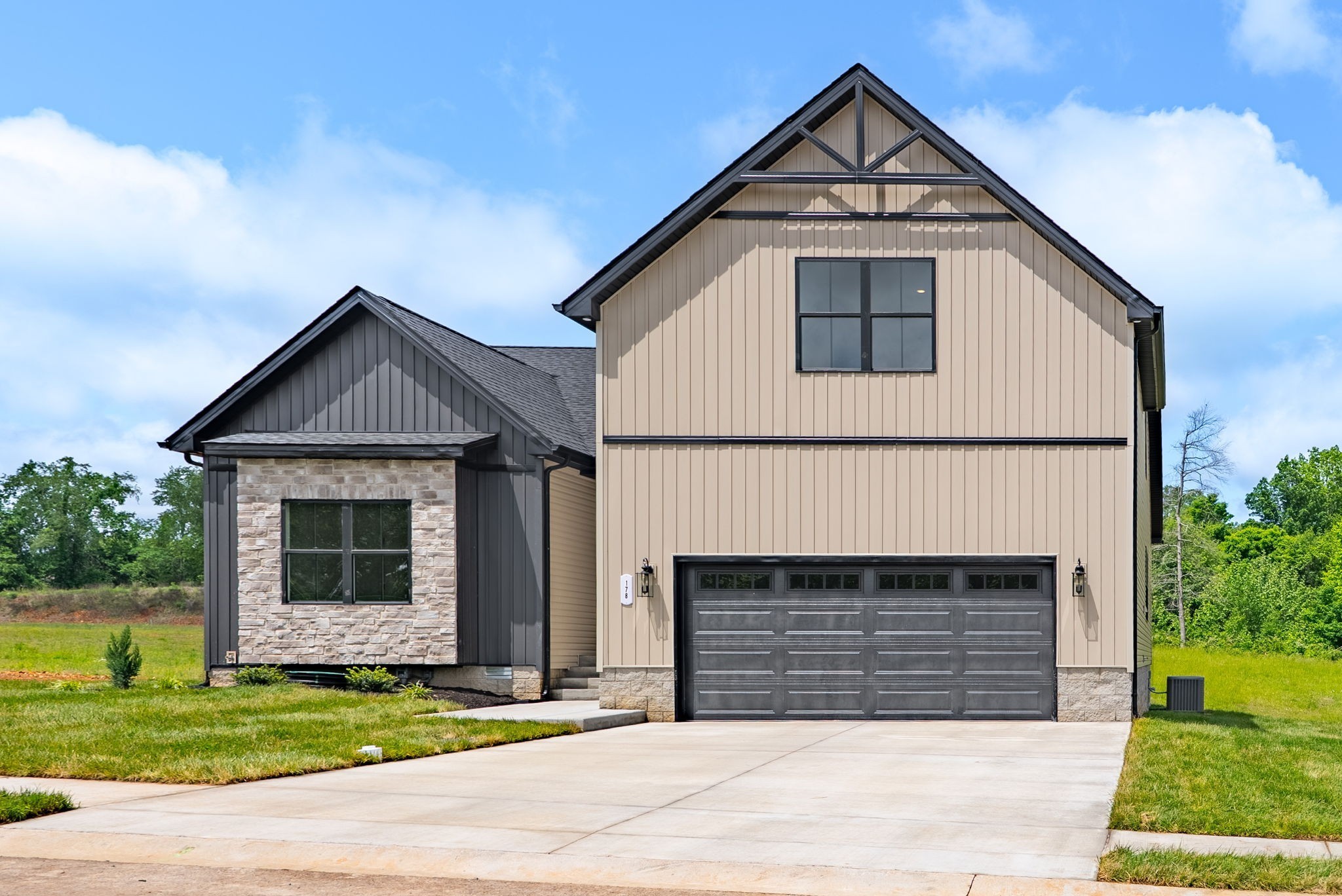 185 Dewberry Road Clarksville, TN 37042 - Photo 6 of 75 a front view of a house with a yard and garage