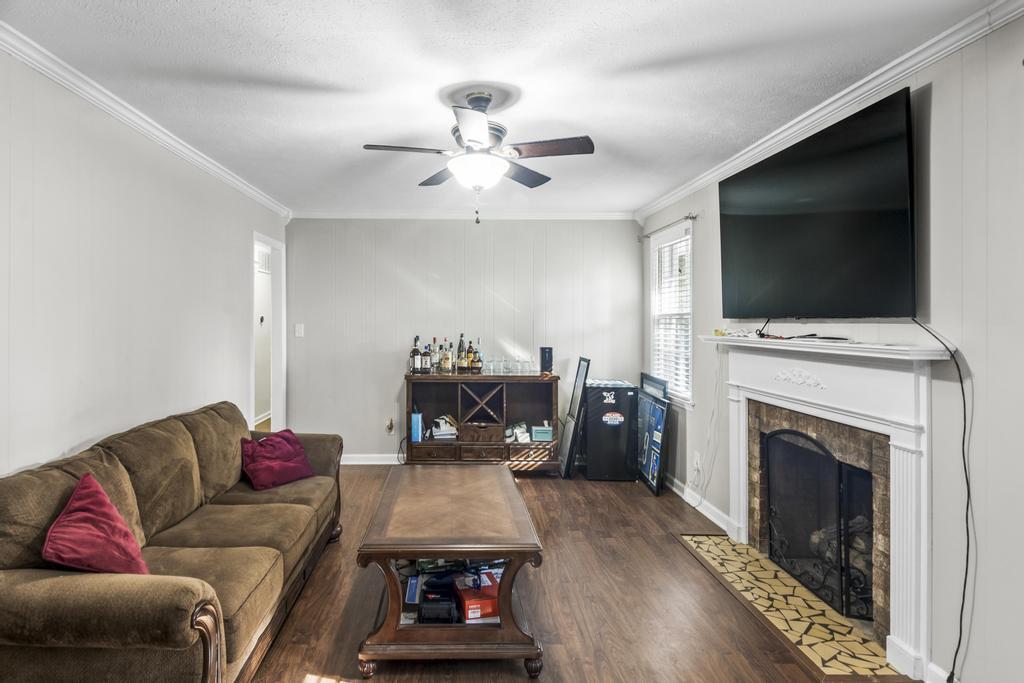 1934 Huntsman Drive Aiken, SC 29803 - Photo 10 of 19 a living room with furniture a flat screen tv and a fireplace