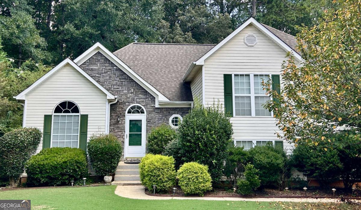 a front view of a house with a yard garage and outdoor seating