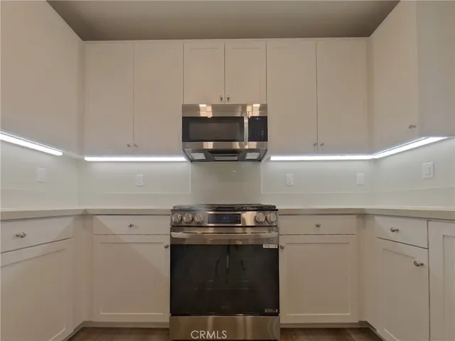 a stove top oven sitting inside of a kitchen