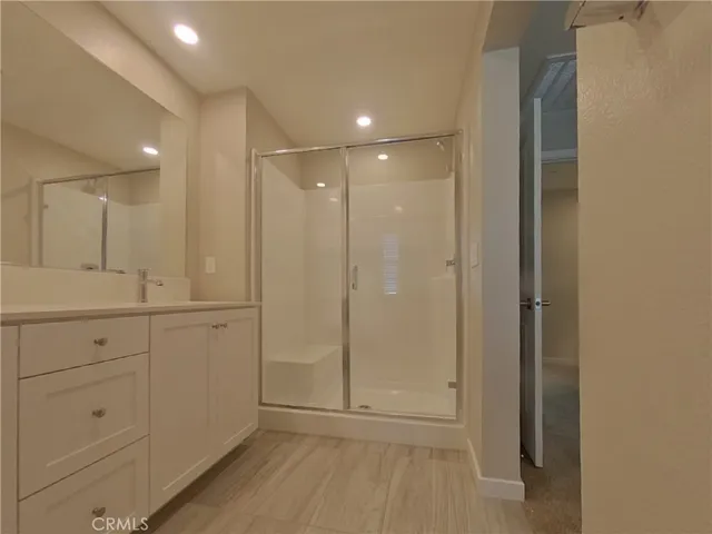 a bathroom with a shower sink and mirror