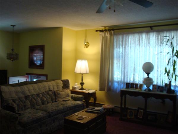 32 Harrisville Road Putnam, CT 06260 - Photo 7 of 11 a living room with furniture and a lamp