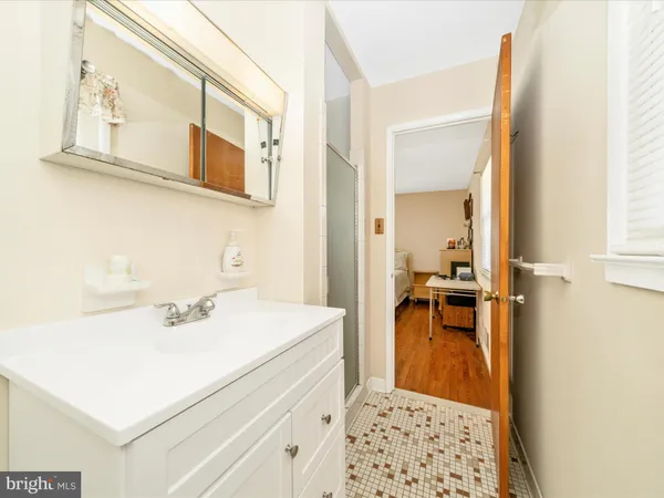 a en suite bathroom with a sink a mirror and a shower