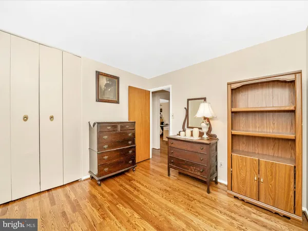 a view of bedroom with furniture and wooden floor