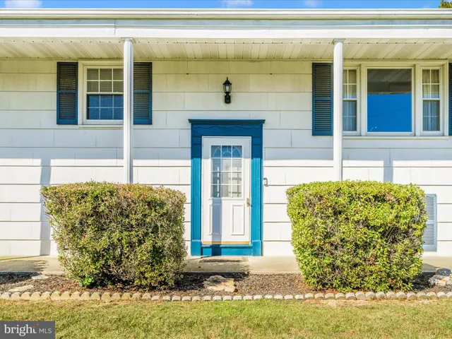 a view of a staircase with white walls and a floor to ceiling window